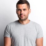 Man in gray shirt, white background.