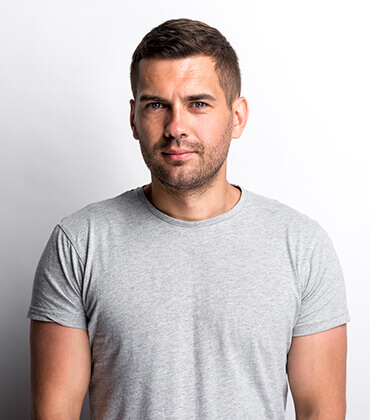 Man in gray shirt, white background.