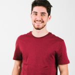 Smiling man in a red shirt.